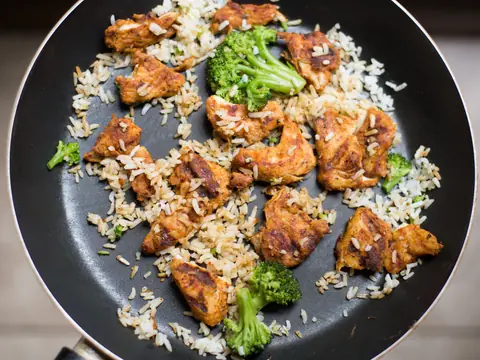 Rice, chicken and broccoli in a frying pan